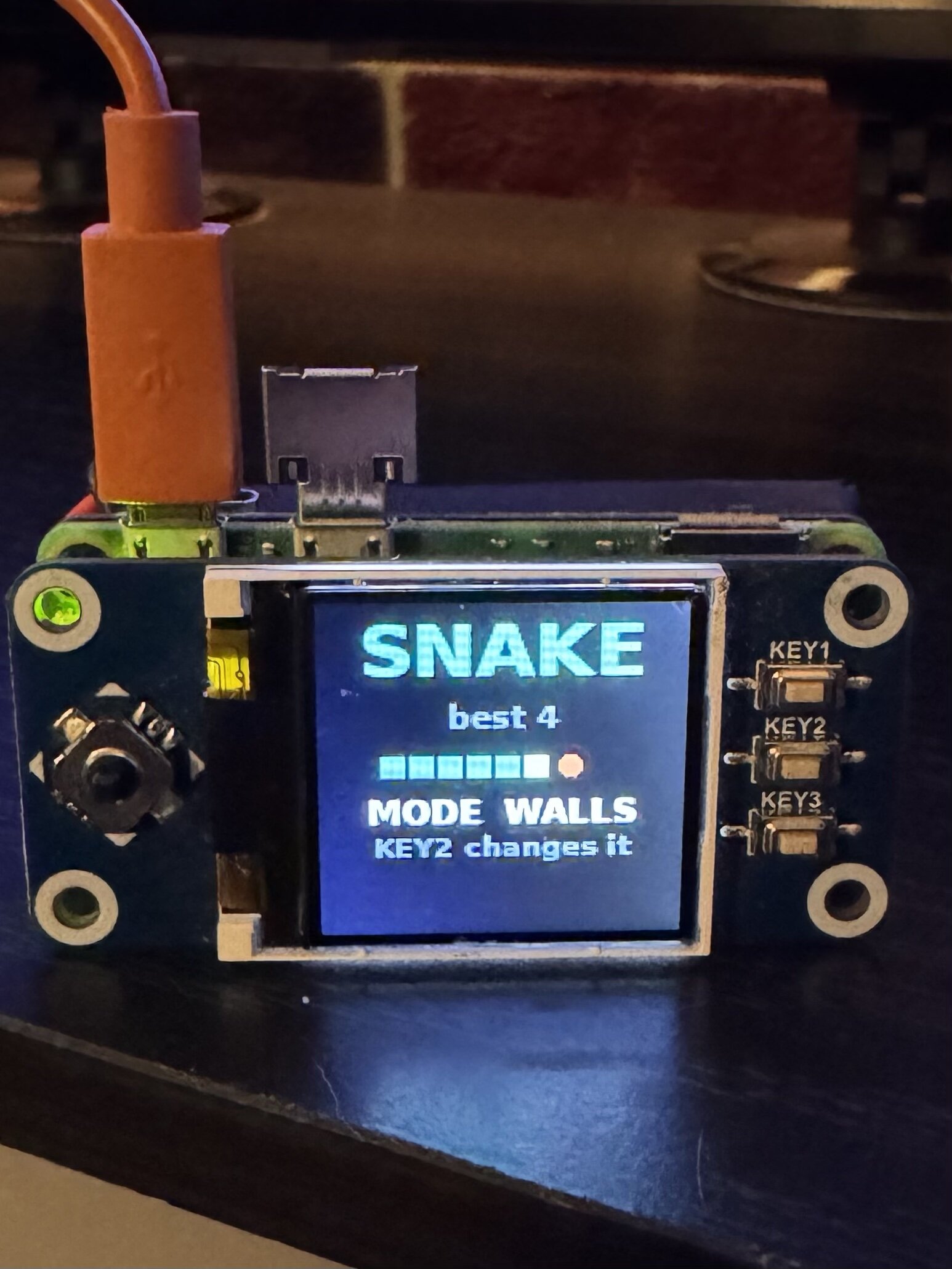 Snake title screen on the 1.44 inch LCD HAT mounted on a Pi Zero 2, showing best 4 and mode walls